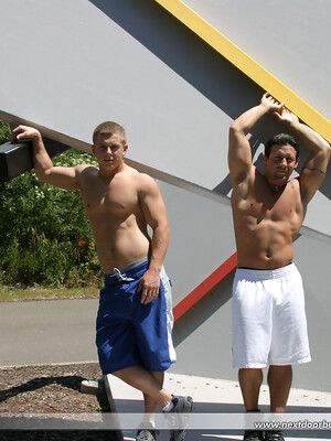 Muscular gay studs Tommy D & Hoyce flaunting their mighty chests outdoors